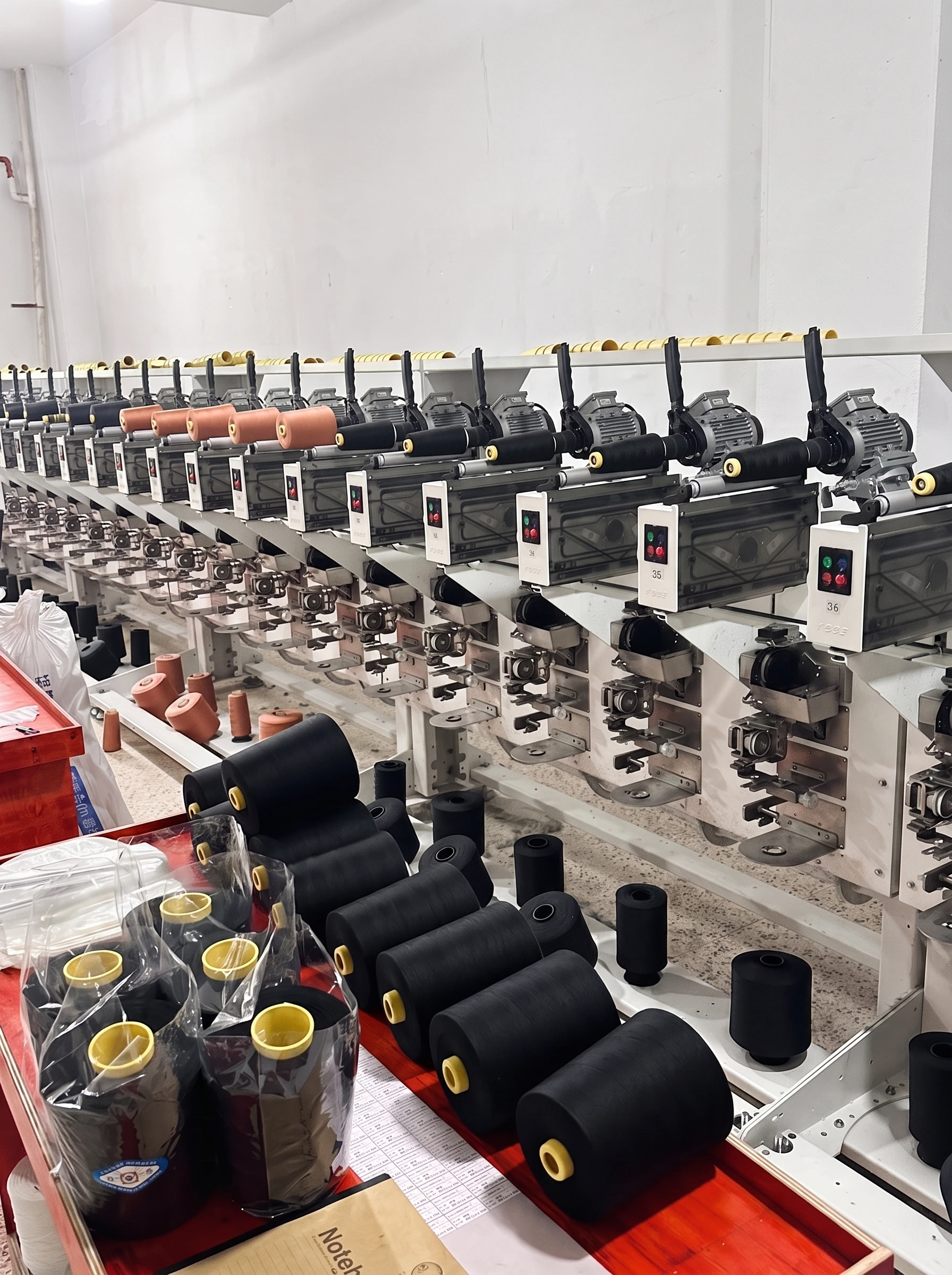 Jingcai production workshop with rows of thread winding equipment